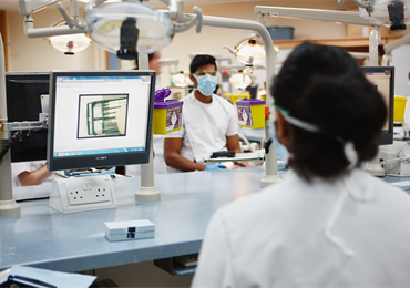 Dental students sat in front of computer screens